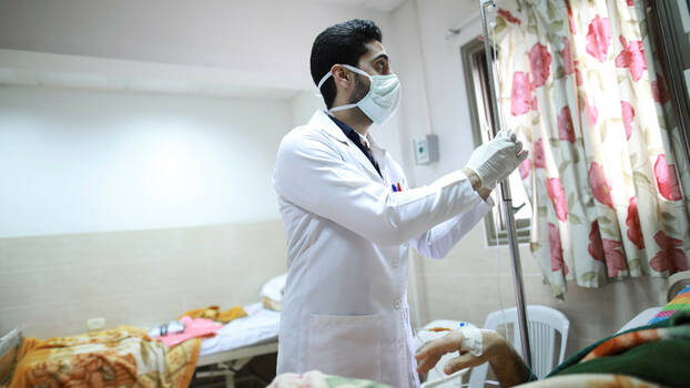 A young male doctor ist visiting patients in a hospital