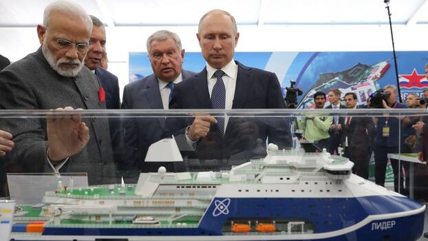 Narendra Modi and Vladimir Putin view a model of a nuclear-powered icebreaker during a visit to the Zvezda shipyard 30 kilometres from Moscow.