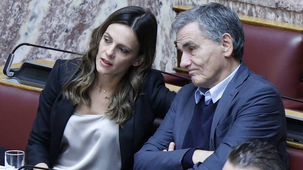 Former Minister of Labour Effie Achtsioglou and former Minister of Finance Euclid Tsakalotos, who both left Syriza following the election of Stefanos Kasselakis, listen to a debate in the Greek parliament, 13 December 2023.