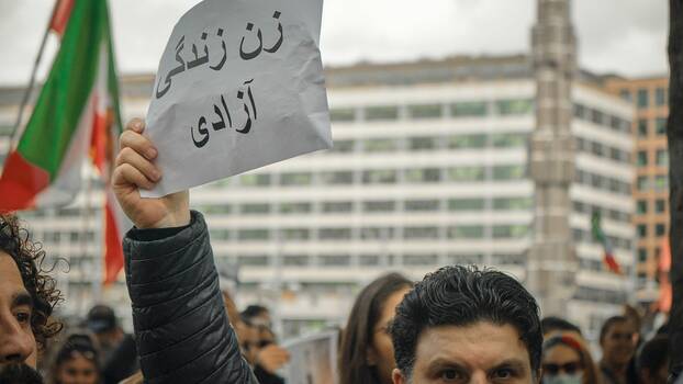 A protester holds up a sign in Iran.