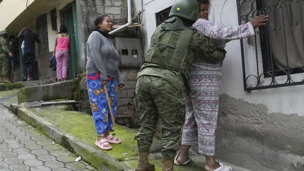 Soldiers search women as they patrol the south side of Quito, Ecuador, Friday, Jan. 12, 2024